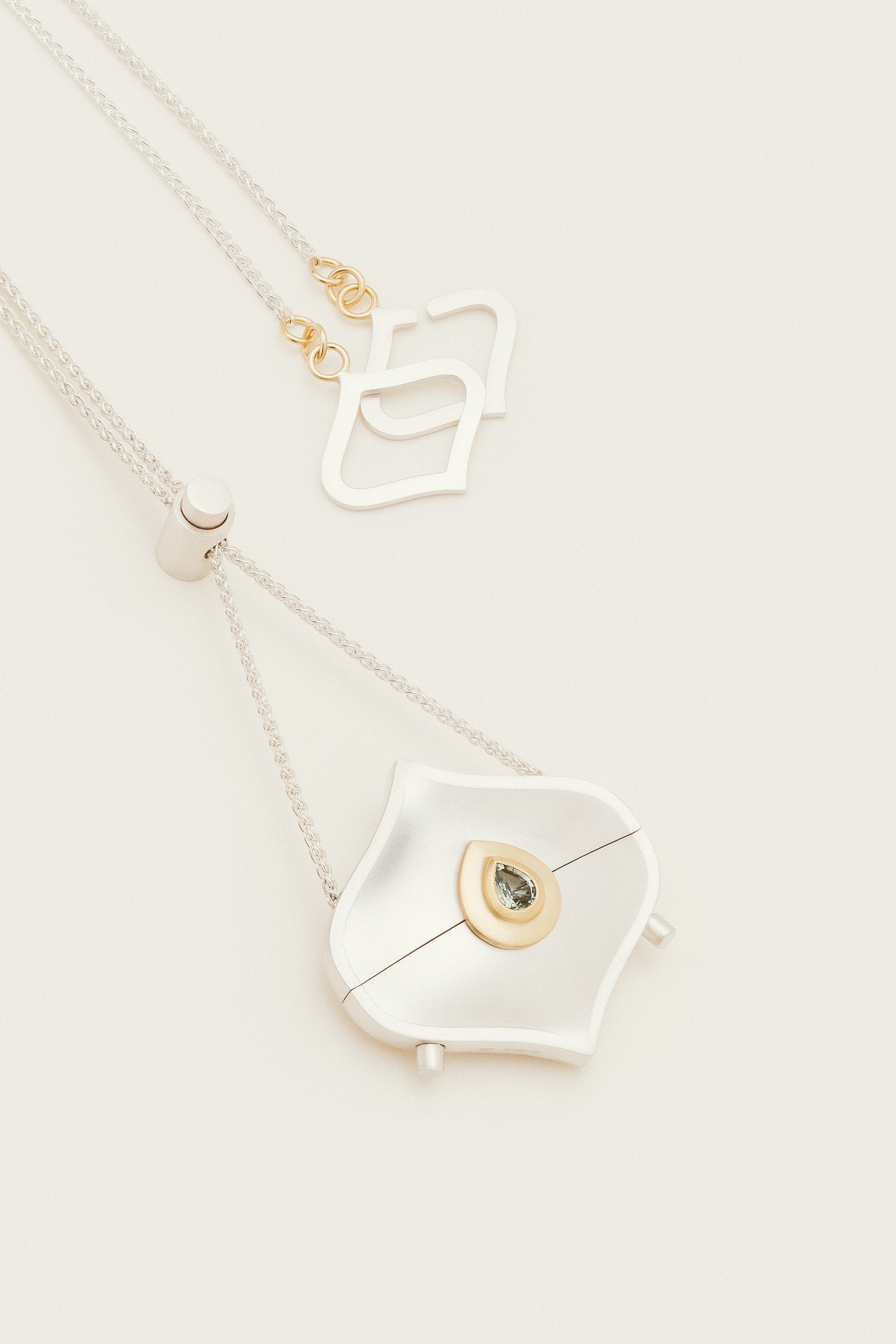 The Alborz Locket, handmade with silver and 18ct gold by Moznabi Jewellery.
