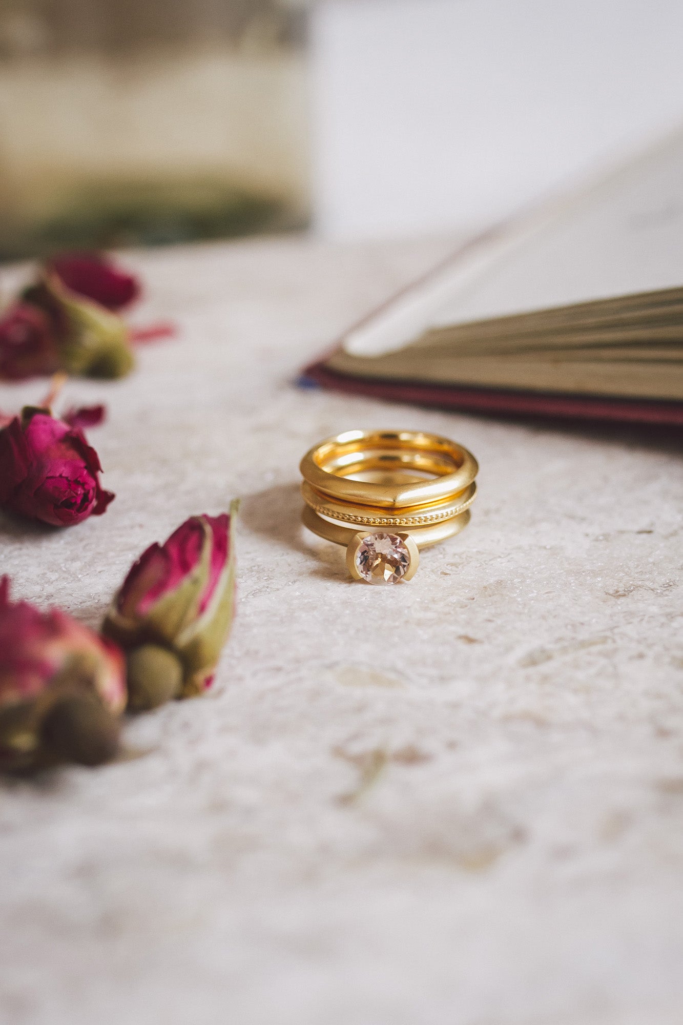 The Aroosi Round Morganite Ring paired with two gold wedding bands