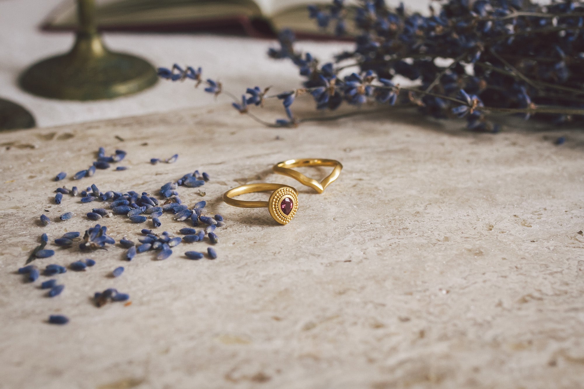 Aroosi Ruby & Garnet Ring paired with fitted gold wedding band