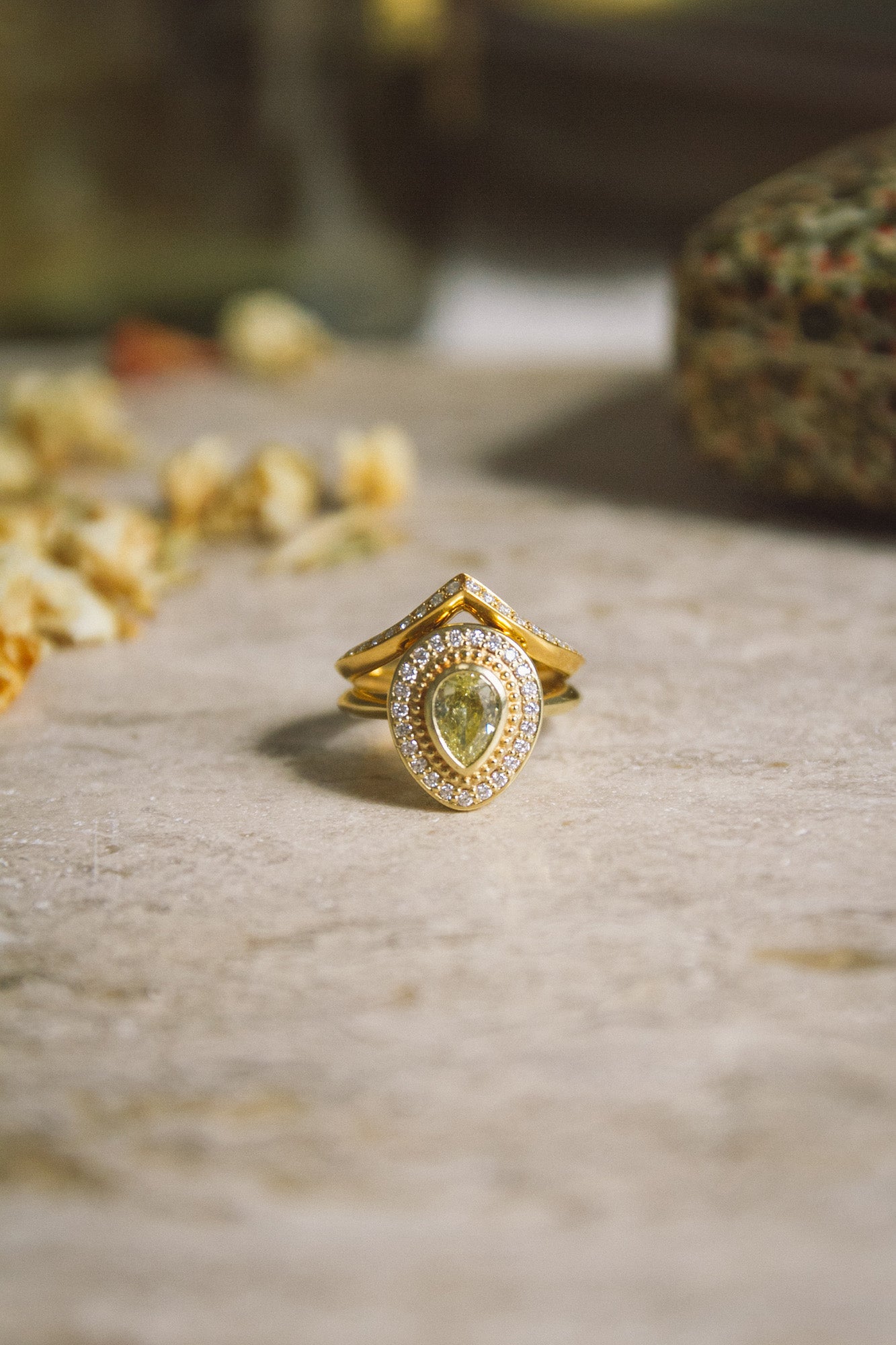 Handmade gold wedding band stacked with Aroosi Yellow Pear Diamond Halo Ring