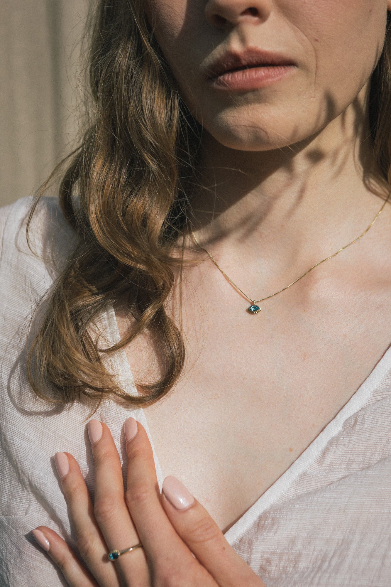 Handmade Cheshm Gold Pendant on a model