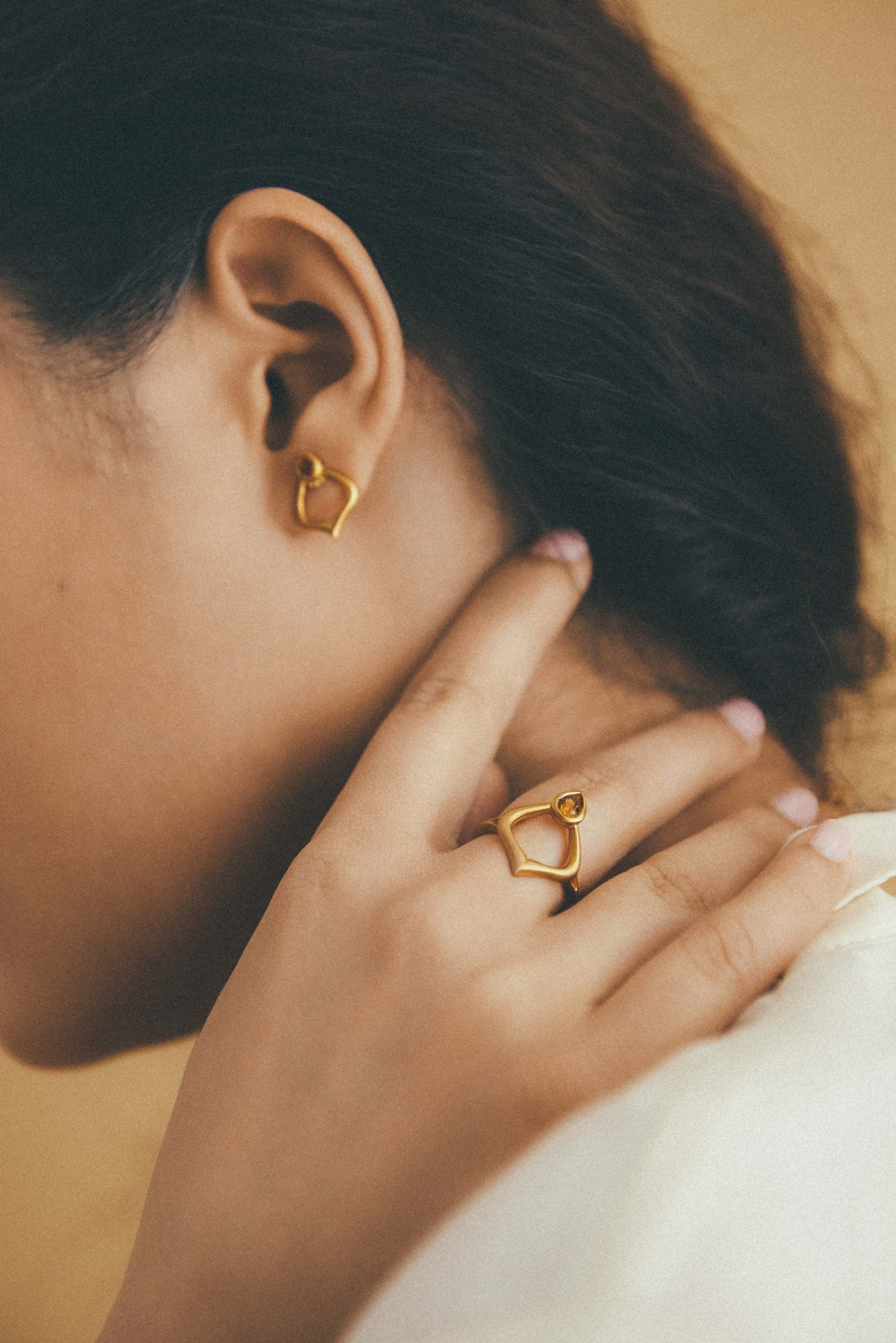 Model wearing Alborz Ring and matching studs, handmade by Roxanna Moznabi